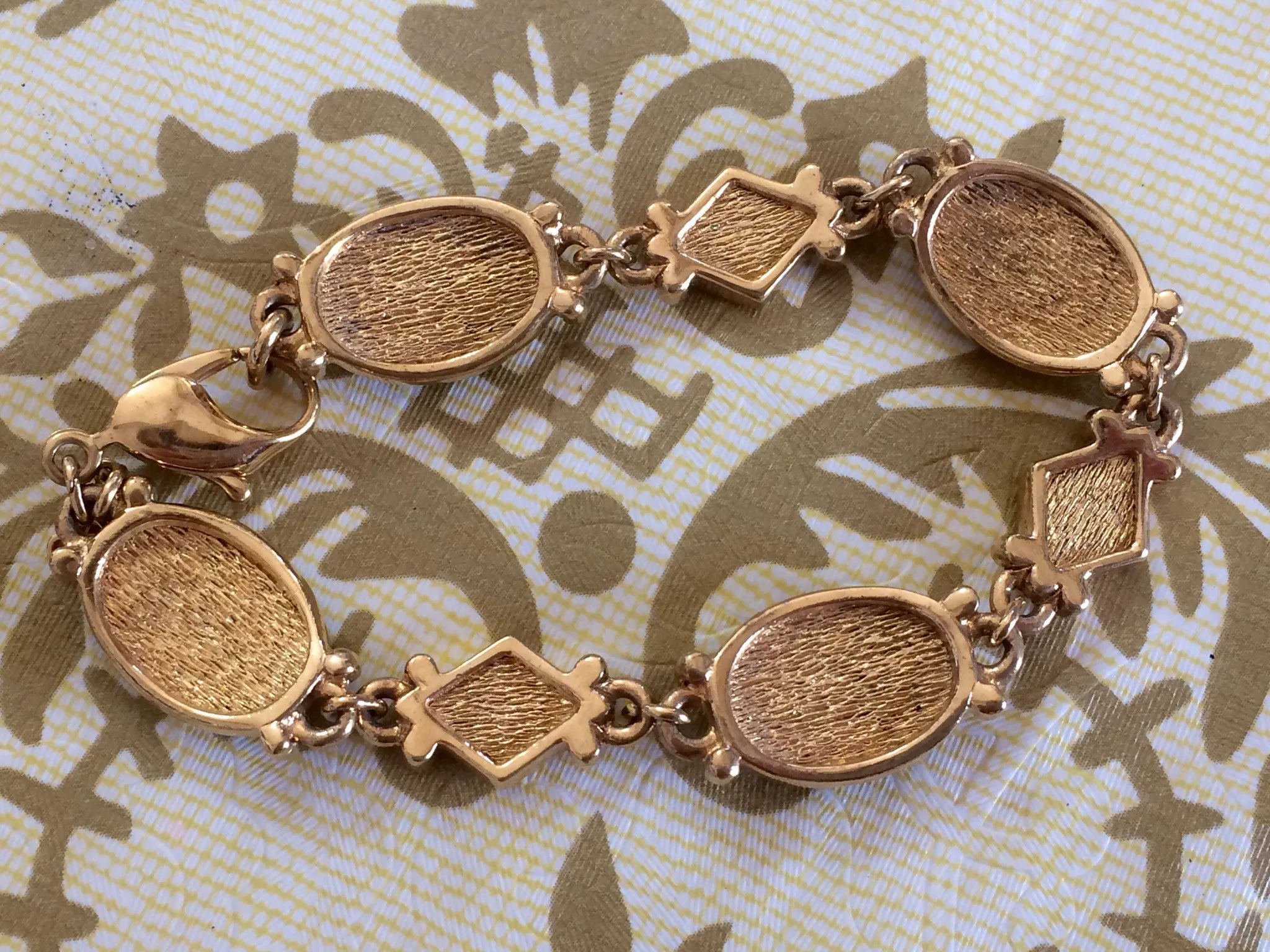 Vintage Burberrys golden gorgeous bracelet with oval emerald green and diamond shape charms with rhinestone crystals. Burberry jewelry.